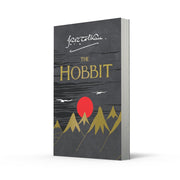 Paperback of The Hobbit fantasy novel by J. R. R. Tolkien, published by HarperCollins, showing the book cover with artwork.