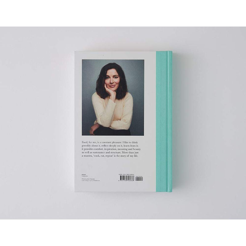 Hardcover cookbook "Cook, Eat, Repeat" by Nigella Lawson featuring ingredients, recipes, and stories on the cover.