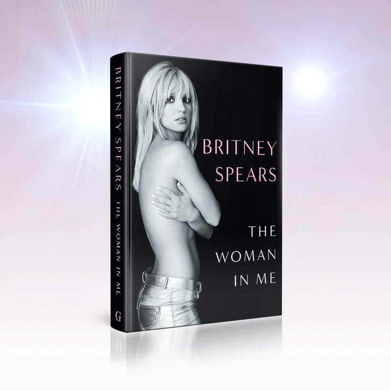 Hardcover book titled "The Woman in Me" by Britney Spears featuring a cover image of Britney Spears on a white background