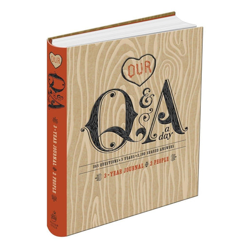 Open journal with daily Q&A prompts for two people, titled "Our Q and A a Day: 3-Year Journal" by Potter Style.