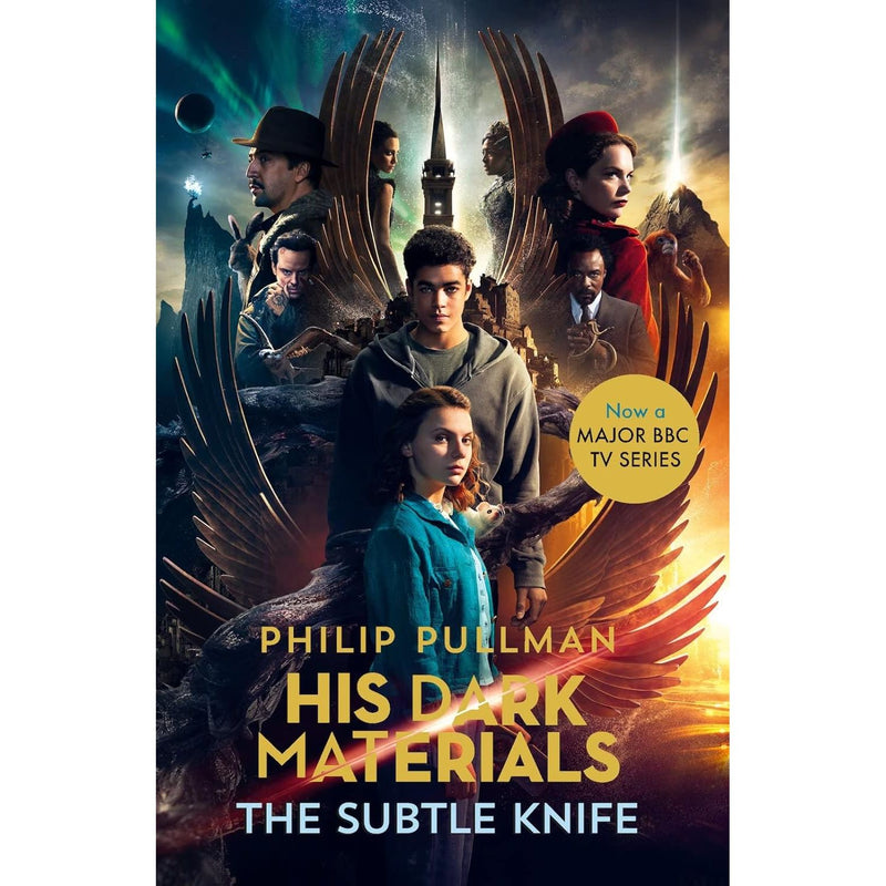 Paperback copy of The Subtle Knife by Philip Pullman, Young Adult fantasy novel, Scholastic edition with colorful cover art.