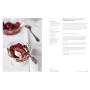 Hardcover cookbook "Mezcla: Recipes to Excite" by Ixta Belfrage, featuring colorful dish photos and vibrant culinary pages.