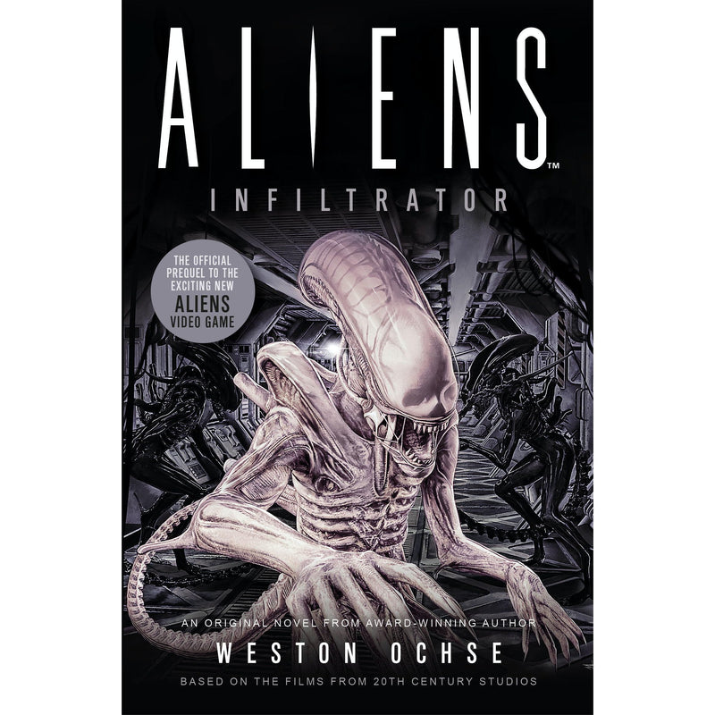 Paperback copy of Aliens: Infiltrator fiction book by Titan Books UK, featuring cover art related to the Alien franchise.