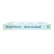 Paperback book titled "Dare to Lead" by Brene Brown, featuring a cover with bold text and author photo on the Random House Publishing Group edition.