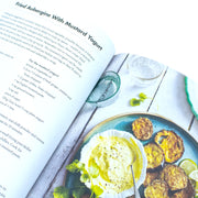 Book cover of "Meat Free Mowgli" by Nisha Katona, featuring colorful Indian-inspired food illustrations on a white background.