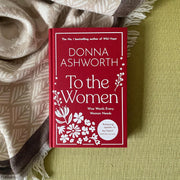Hardcover copy of "To the Women" by Donna Ashworth, featuring black and white cover design with inspiring title text.