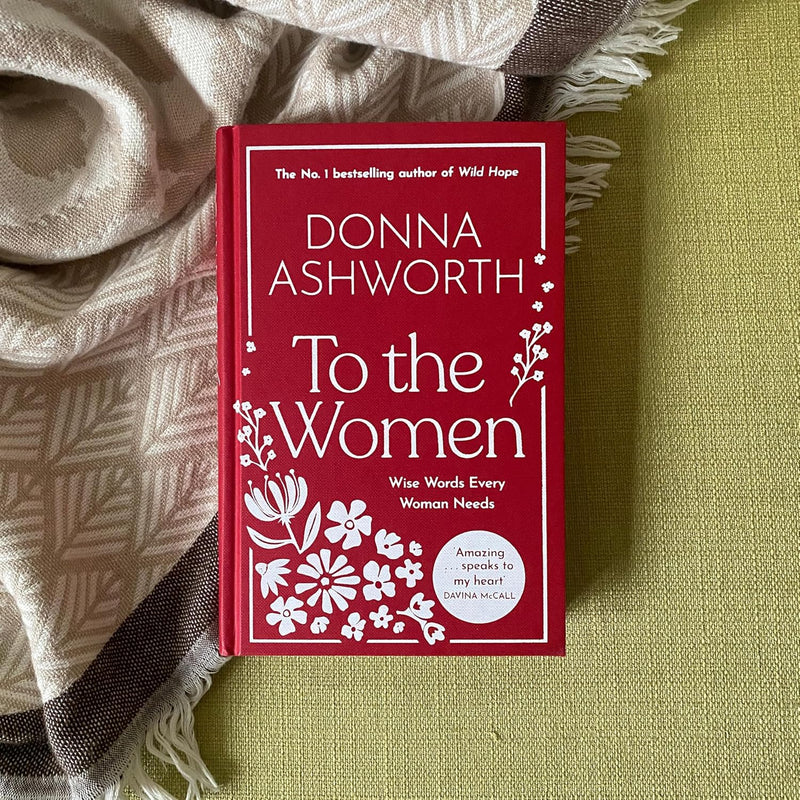 Hardcover copy of "To the Women" by Donna Ashworth, featuring black and white cover design with inspiring title text.
