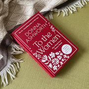 Hardcover book titled "To the Women" by Donna Ashworth, featuring black and white cover art with inspiring wise words for women.