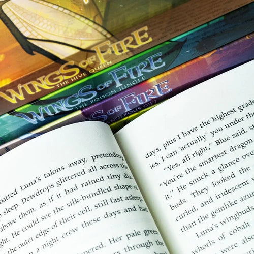 Set of five Wings of Fire series books by Tui T. Sutherland, featuring colorful dragon illustrations on the covers.