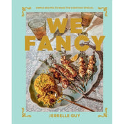 Two hardcover cookbooks from the We Fancy and Nom Nom Chinese Takeaway series by Jerrelle Guy and Iota, featuring simple recipes.