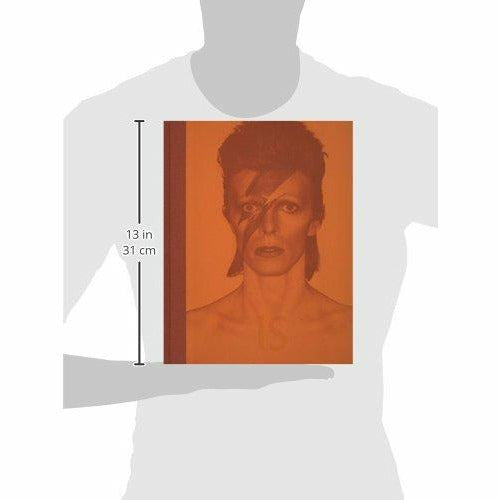 Hardcover David Bowie Is exhibition catalogue by V & A Publications featuring images of Bowie’s art and music memorabilia.