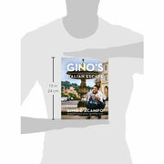 Hardcover copy of Gino's Italian Escape by Gino D'Acampo, featuring a colorful book cover with Italian culinary themes.