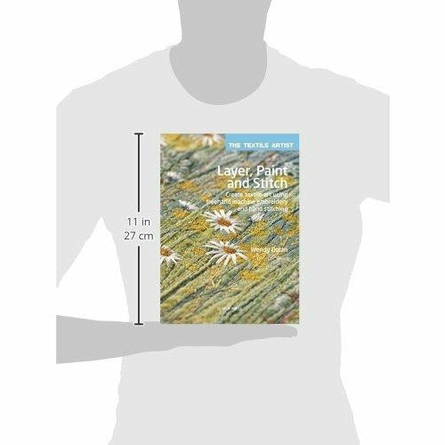 Paperback book titled "Layer, Paint and Stitch" by Wendy Dolan showcasing textile art and freehand machine embroidery techniques.