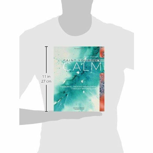 Open watercolor book titled "Paint Yourself Calm" by Jean Haines, showing colorful watercolor artwork on the cover.