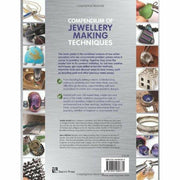 Open paperback of "Compendium of Jewellery Making Techniques" by Xuella Arnold and Sara Withers, showing pages with jewelry design tips.