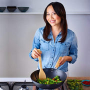 Paperback book titled "Eat Clean: Wok Yourself to Health" by Ching-He Huang, featuring a cover with Asian-inspired design and healthy eating themes.