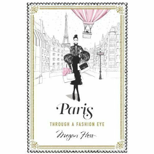 Illustrated hardcover travel guide "Paris: Through a Fashion Eye" by Megan Hess, featuring stylish Parisian scenes and fashion-inspired artwork.