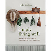 Hardcover of "Simply Living Well" by Julia Watkins, a guide to creating a natural, low-waste home with eco-friendly lifestyle tips.