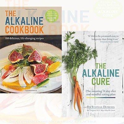 Set of two hardcover books by The Book Bundle, The Alkaline Cookbook and The Alkaline Cure, featuring health and nutrition tips.