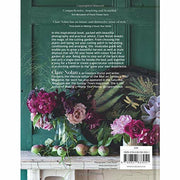 Hardcover book titled "In Bloom" by Clare Nolan, showing colorful flower illustrations on the cover.