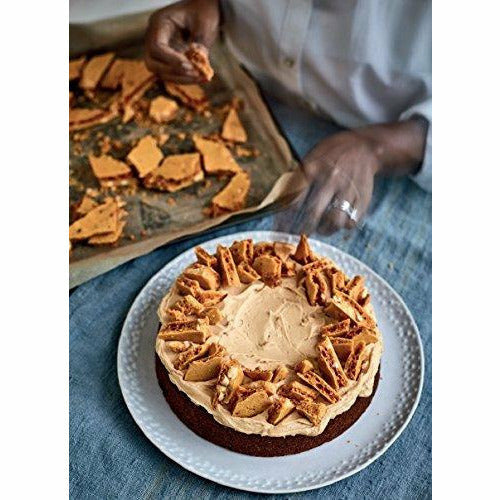 Hardcover book cover of "Nadiya's Family Favourites" by Nadiya Hussain, featuring colorful, appetizing dish photos on the cover.