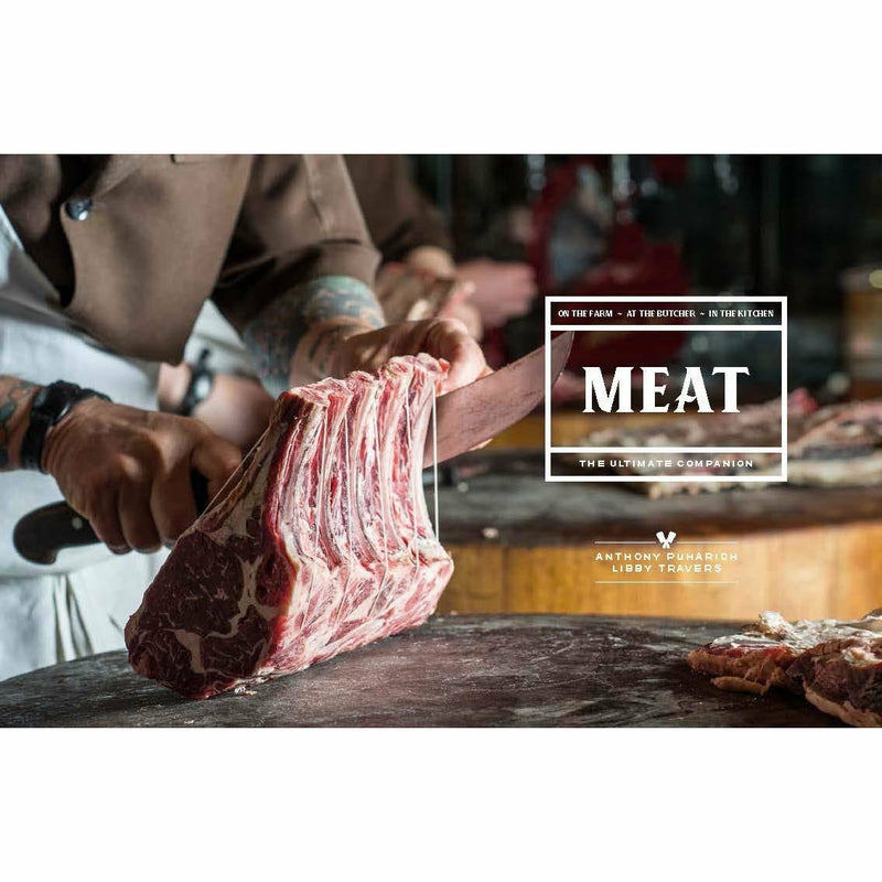 Hardcover copy of "Meat: The Ultimate Companion" by Anthony Puharich, featuring a close-up of the book cover with meat-themed imagery.