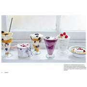 Hardcover copy of "The Art of Eating Well" by Jasmine and Melissa Hemsley, featuring a colorful food-themed cover.