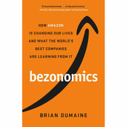 Stack of two non-fiction books, "Bezonomics" by Brian Dumaine and "Becoming Bulletproof" by Evy Poumpouras, on a neutral background.