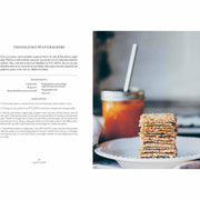 Hardcover book titled "Simply Living Well" by Julia Watkins, featuring a natural, eco-friendly home lifestyle on the cover.