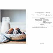 Hardcover copy of "Simply Living Well" by Julia Watkins, a guide to creating a natural, low-waste home, with a clean design.
