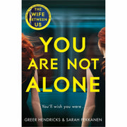 Set of three Greer Hendricks & Sarah Pekkanen books: The Wife Between Us, An Anonymous Girl, and You Are Not Alone, stacked on a pan.