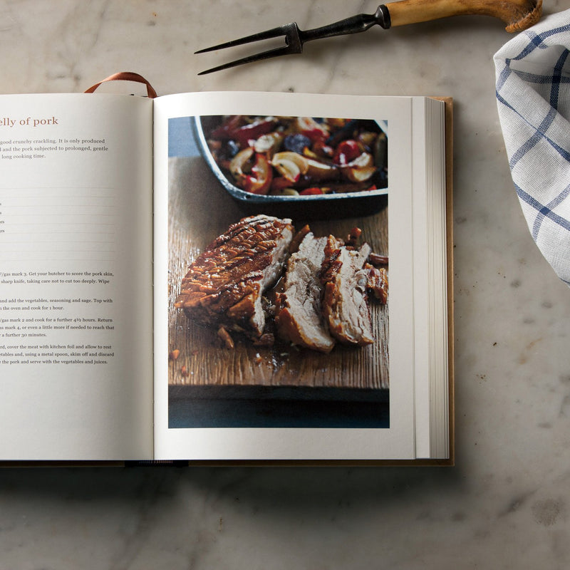 Hardback copy of Ginger Pig Meat Book by Tim Wilson & Fran Warde, featuring meat buying, preparation, and cooking tips.