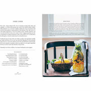 Hardcover book titled "Simply Living Well" by Julia Watkins, featuring a natural, eco-friendly home on the cover.