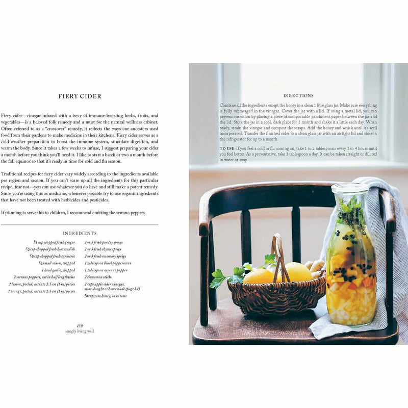 Hardcover book titled "Simply Living Well" by Julia Watkins, featuring a natural, eco-friendly home on the cover.