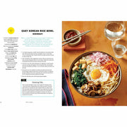 Tasty Ultimate Cookbook hardcover by Tasty, featuring colorful pages with recipes for easy meals and impressive feasts.