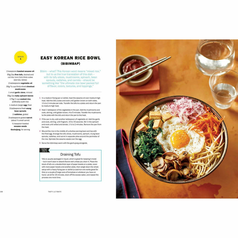 Tasty Ultimate Cookbook hardcover by Tasty, featuring colorful pages with recipes for easy meals and impressive feasts.