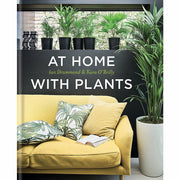 Hardcover book titled "At Home With Plants" by Ian Drummond and Kara O'Reilly, featuring indoor plant decor ideas.