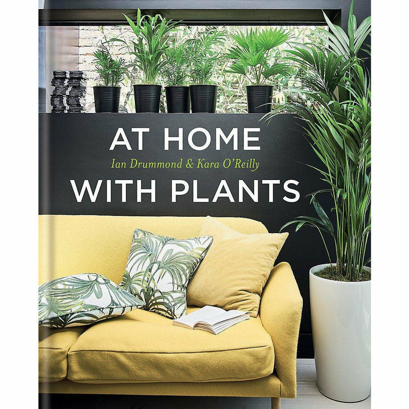 Hardcover book titled "At Home With Plants" by Ian Drummond and Kara O'Reilly, featuring indoor plant decor ideas.