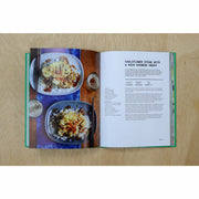 Hardback copy of The Veggie Chinese Takeaway Cookbook by Kwoklyn Wan, featuring colorful dish images and wok cooking tips.