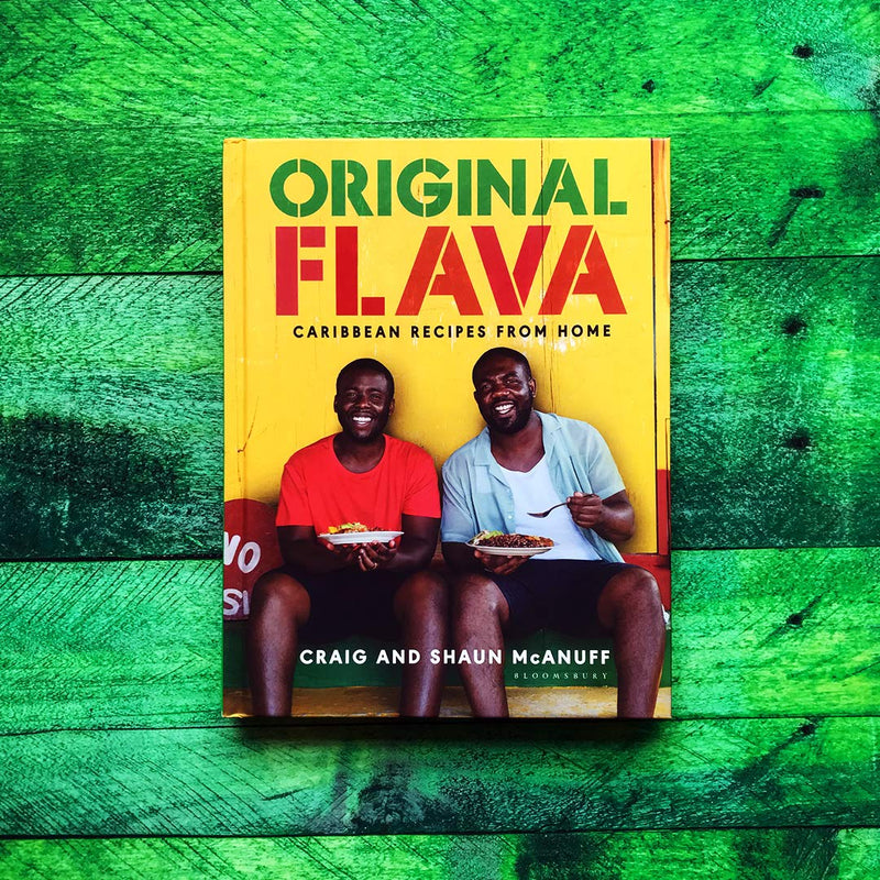 Hardcover book titled "Original Flava: Caribbean Recipes From Home" by Craig McAnuff, featuring vibrant Caribbean cuisine images.