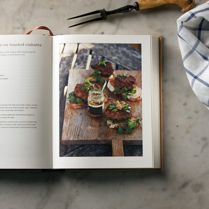 Hardcover of Ginger Pig Meat Book by Tim Wilson & Fran Warde, featuring meat cuts and cooking tips from Mitchell Beazley.