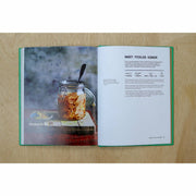 Hardback copy of The Veggie Chinese Takeaway Cookbook by Kwoklyn Wan, featuring colorful dish photographs and a wok on the cover.