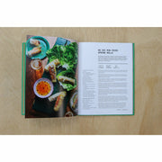 Hardcover copy of The Veggie Chinese Takeaway Cookbook by Kwoklyn Wan, featuring colorful vegetable dishes and wok cooking tips.