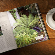 Hardcover RHS Small Garden Handbook by Andrew Wilson, showcasing tips for maximizing outdoor space with garden design ideas.