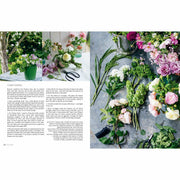 Clare Nolan's hardcover book "In Bloom" showing colorful flowers and gardening tools on the cover for year-round flower arranging.