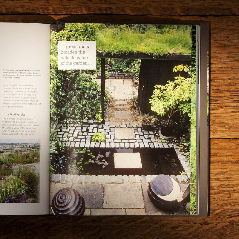 Hardcover of RHS Small Garden Handbook by Andrew Wilson, showing the book cover with garden illustrations and title.
